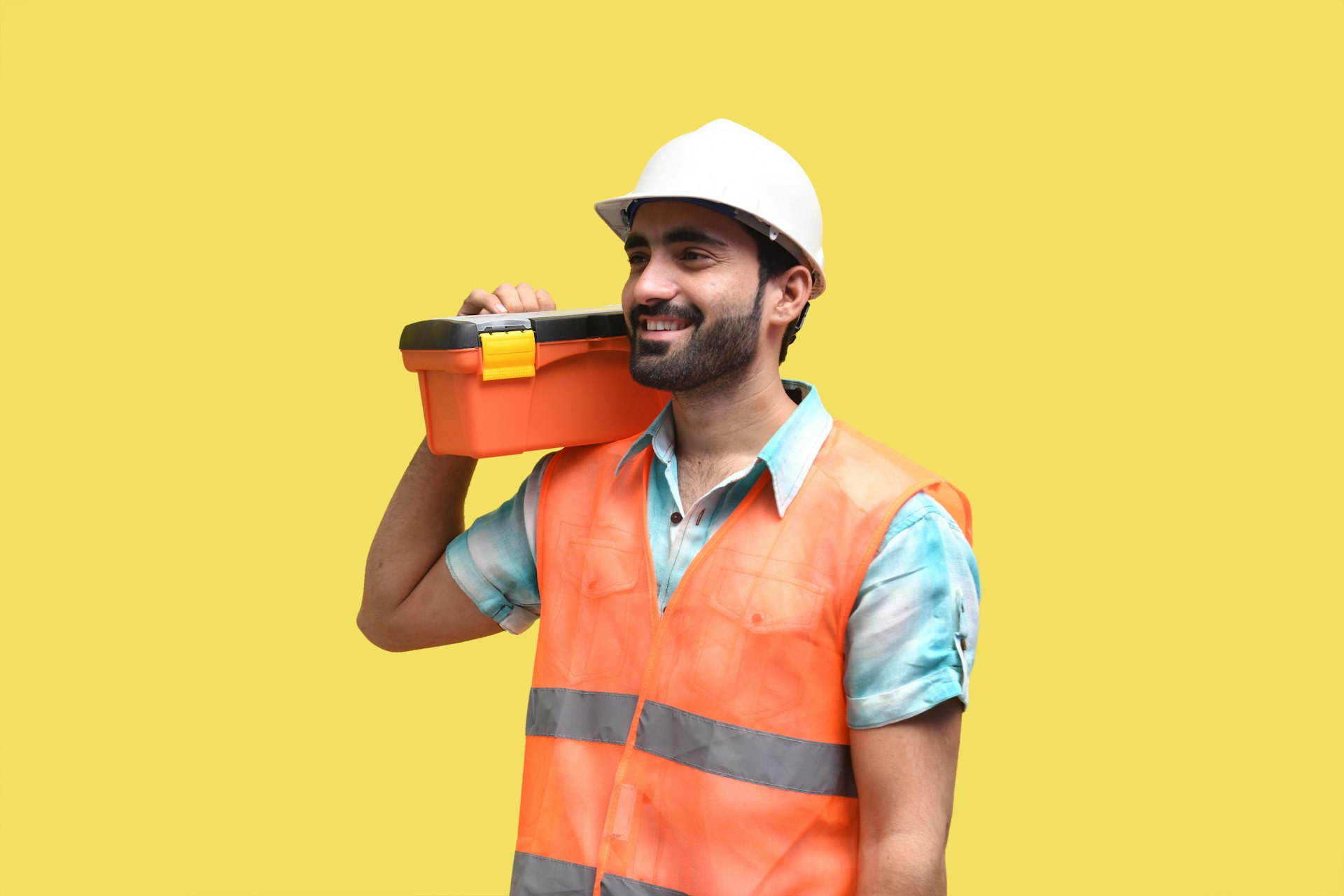 a person wearing a hard hat and holding a drill